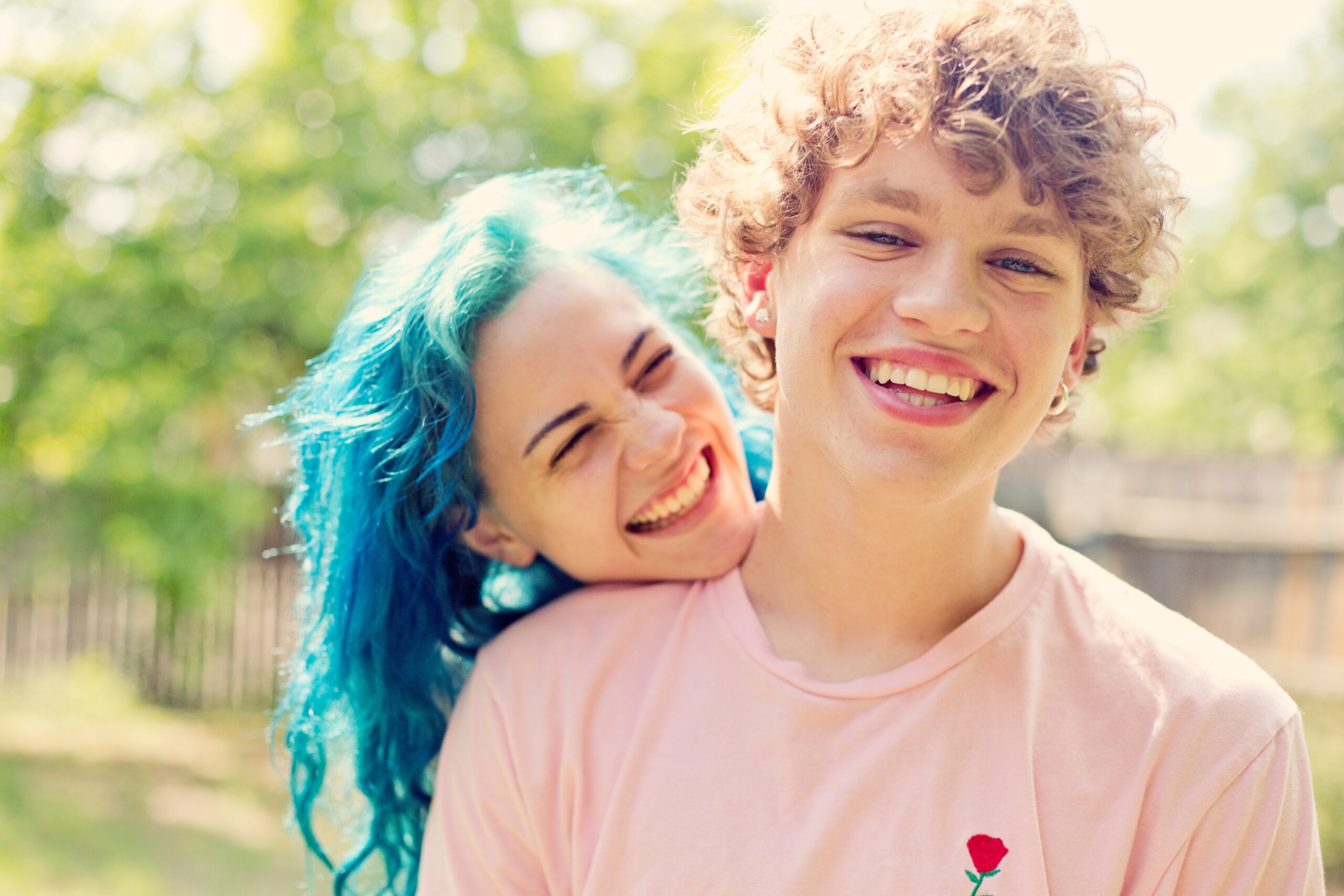 smiling man and woman near trees 2538505 scaled